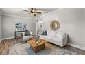 Bright living room with neutral colors, hardwood floors, a wood coffee table, and stylish furnishings at 126 Duncan Trl, Longwood, FL 32779