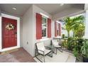 Cozy front porch featuring outdoor seating, a decorative wreath on the door, and brick flooring at 13227 Spring Grove Way, Winter Garden, FL 34787