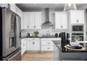 Well-designed kitchen with white cabinetry, a geometric backsplash, and stainless steel appliances at 1341 Lumpini St, St Cloud, FL 34771