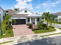 Inviting single-Gathering home with a two-car garage, covered porch and colorful brick driveway and walkway at 1382 Foltz Loop, Oakland, FL 34787