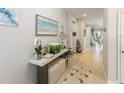 Inviting hallway with stylish decor, wood floors, and plenty of natural light at 1382 Foltz Loop, Oakland, FL 34787