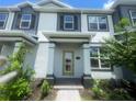 Close up of the Townhouse entry featuring a light-filled doorway and well-kept landscaping, offering an inviting entrance at 1411 Mount Royal Dr, St Cloud, FL 34771