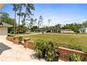Side exterior view showing brick accents and tidy neighborhood at 14612 Bray Rd, Orlando, FL 32832