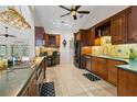 Well-equipped kitchen with custom wood cabinets, stainless steel appliances, and elegant lighting at 14612 Bray Rd, Orlando, FL 32832