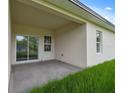 A covered patio provides a great view with a sliding glass door, and a grassy lawn at 14930 Sw 66Th Ave Rd, Ocala, FL 34473