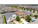 Aerial view of the property nestled in a vibrant neighborhood with well-maintained landscaping and convenient street access at 1505 Nassau Point Trl, Kissimmee, FL 34747