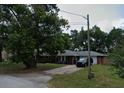View of the charming one-story home with a front lawn and ample parking on the driveway at 1511 Hobson St, Longwood, FL 32750
