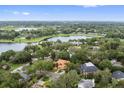 Beautiful aerial view of the neighborhood showcasing the surrounding greenery and scenic lake nearby at 1542 Islay Ct, Apopka, FL 32712