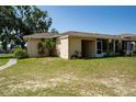 View of the backyard showing the lawn, and a glimpse of an enclosed patio area at 1543 Club Cir, Lakeshore, FL 33854