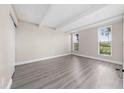 Bedroom featuring light gray flooring, two windows letting in natural light, and an exposed beam ceiling at 1543 Club Cir, Lakeshore, FL 33854