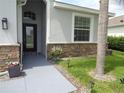 Charming front entrance featuring stone accents, manicured landscaping and a walkway at 2451 Strandhill St, Orlando, FL 32824