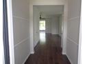 Inviting hallway with hardwood floors leading to a sunlit living area at 2451 Strandhill St, Orlando, FL 32824