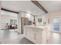 Bright kitchen features a large island, stainless steel appliances, and open layout to the living area at 2603 E Marks St, Orlando, FL 32803