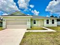Alluring single-story home with a lush green lawn and a capacious two-car garage at 2645 Sw 155Th Ln, Ocala, FL 34473