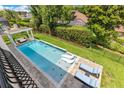 Overhead angle of a well-designed backyard pool with lounge chairs, a nearby gazebo and green lawn at 283 Lakay Pl, Longwood, FL 32779