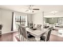 Formal dining area with elegant table, seating, hardwood flooring, and ample natural light at 3038 Golden Rock Dr, Orlando, FL 32818