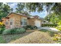 Attractive brick home boasting a two-car garage, well-kept lawn, and inviting curb appeal at 316 Dornoch Ct, Winter Springs, FL 32708
