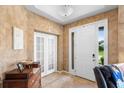 Bright entryway with tile flooring, a white front door, and a view of the outside at 3551 Statham Dr, Apopka, FL 32712