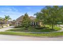 Charming home with a meticulously landscaped yard, lush lawn, mature trees and a welcoming curb appeal at 3551 Statham Dr, Apopka, FL 32712