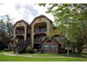 A condo with dual balconies surrounded by trees at 380 Lake Ontario Ct # 304, Altamonte Springs, FL 32701