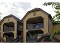 Condo building exterior featuring balconies with dark railings and wood siding at 380 Lake Ontario Ct # 304, Altamonte Springs, FL 32701
