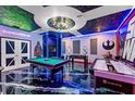 Spacious game room with a pool table, foosball table, and Star Wars decor at 4161 Paragraph Dr, Kissimmee, FL 34746