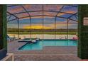 Beautiful screened pool with a lake view, perfect for relaxing and entertaining guests at 4161 Paragraph Dr, Kissimmee, FL 34746