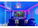 Modern theater room with comfortable seating, large screen, and themed decorations at 4161 Paragraph Dr, Kissimmee, FL 34746