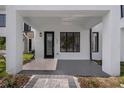 Inviting front porch with modern design, featuring a black door and clean lines at 523 W Princeton St # 1, Orlando, FL 32804