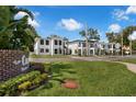 View of new white modern homes with balconies along a street and lush landscaping at 523 W Princeton St # 1, Orlando, FL 32804