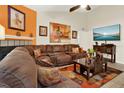Relaxing living room features a sectional sofa, fireplace and modern entertainment setup at 5545 Devonbriar Way # 206, Orlando, FL 32822