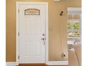 Bright white front door with decorative glass and classic hardware, offering a welcoming entry at 676 Dunblane Dr, Winter Park, FL 32792