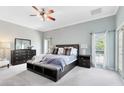 Serene main bedroom featuring neutral tones, a ceiling fan, and an ensuite bathroom at 718 Glen Eagle Dr, Winter Springs, FL 32708