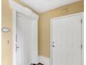 Bright hallway with white doors and yellow walls at 7650 Whisper Way # 104, Reunion, FL 34747