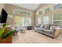 Bright living room featuring large windows, tile flooring, and neutral tones creating a relaxing and inviting atmosphere at 8507 Crystal Cove Loop, Kissimmee, FL 34747