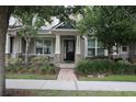 Charming front porch with stone accents and manicured landscaping, offering a welcoming entrance at 8670 Vedder Ln, Orlando, FL 32832