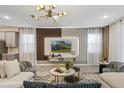 Sleek living room boasting a large sectional, contemporary lighting, and a stylish entertainment center for ultimate comfort at 8928 Coconut Breeze Dr, Kissimmee, FL 34747