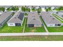 Backyard aerial view of a fenced property with a screened-in patio and green grass at 927 Denali Dr, Orange City, FL 32763