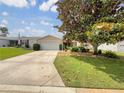 Lovely single-story home with a well-kept lawn and mature landscaping, creating great curb appeal at 9514 Se 168Th Maplesong Ln, The Villages, FL 32162
