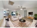 Bright living room featuring tile floors, neutral walls, and sliding door access to outdoor space at 9514 Se 168Th Maplesong Ln, The Villages, FL 32162