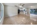 Open-concept living space with tile flooring, neutral paint, and an abundance of natural light at 9514 Se 168Th Maplesong Ln, The Villages, FL 32162