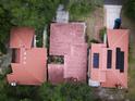 Aerial view showcasing the red tile roofs, solar panels, and well-maintained landscaping of the property at 1053 W Pebble Beach Cir, Winter Springs, FL 32708