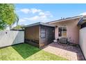 Cozy backyard with a screened-in patio, artificial grass, and brick pavers at 1312 Azalea Way, Winter Garden, FL 34787