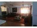 Bright living room featuring hardwood floors, ceiling fan, and natural light at 13200 Mallard Cove Blvd, Orlando, FL 32837