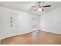 Inviting living room showcasing tile floors, white walls, and natural light from the window at 1447 Candlewyck Dr, Orlando, FL 32807