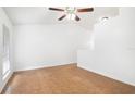 Bright living room with tile flooring, white walls, and ceiling fan at 1447 Candlewyck Dr, Orlando, FL 32807
