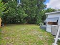 Spacious backyard with lush greenery, providing a private and serene outdoor space, ready for various activities at 1525 Hilltop Rd, Casselberry, FL 32707