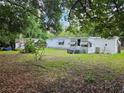 View of the home's rear exterior and yard, showing the additional potential for outdoor enjoyment and expansion at 1525 Hilltop Rd, Casselberry, FL 32707