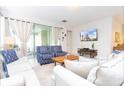 Bright living room featuring stylish furniture and sliding glass doors to the outside at 1625 Nassau Point Trl, Kissimmee, FL 34747