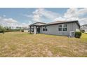 Expansive backyard with a covered patio, offering plenty of space for outdoor activities and relaxation at 17363 Million Lakes Ct, Clermont, FL 34714